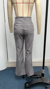 Close-up back view of grey high-waisted corduroy flare pants featuring back pockets