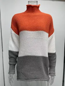 Detailed view of women's color block turtleneck chunky knit sweater in orange and grey
