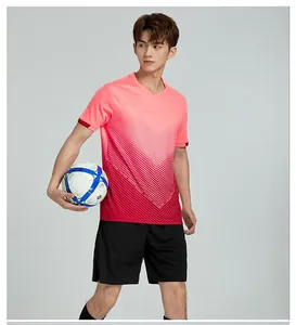 Model wearing a pink and red gradient quick-dry soccer training uniform jersey set
