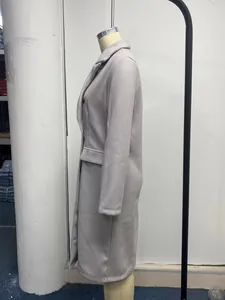 Side view of an elegant light gray long-sleeved wool-mix overcoat on a mannequin.