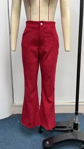 Close-up detail view of solid red high-waisted corduroy flared pants on mannequin