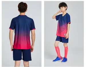 Front and back detail of youth soccer uniform in navy blue and pink gradient.