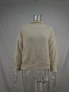 Detailed texture of women's chunky cream knit turtleneck pullover sweater display