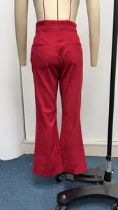 Detailed back view of red high-waisted corduroy flared trousers on a mannequin form.