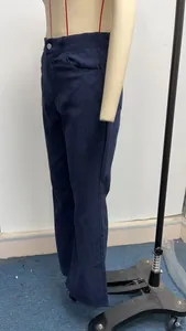 Side profile detail showing the texture of navy blue high-waisted flared corduroy trousers.