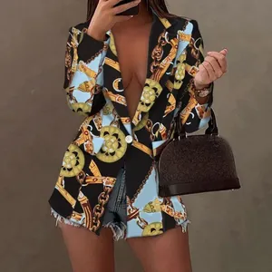 Detail view of a women's blazer with a bold blue and gold baroque chain print pattern.