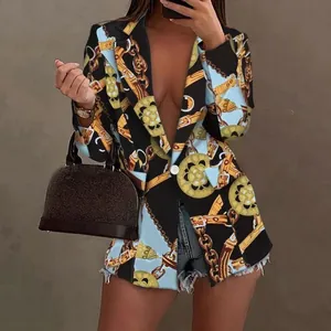 Detail view of women's blazer featuring elegant gold chain and medallion prints