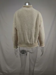 Back view of a beige chunky knit oversized turtleneck sweater featuring ribbed hem and cuffs