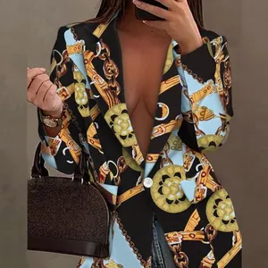 Detail view of a woman wearing a baroque chain print blazer with gold accents and black.