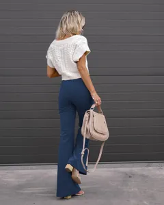 Detail view of high-waisted blue corduroy flare pants for women's spring fashion style