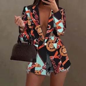 Detail view of women's printed blazer featuring luxury chain and belt motifs