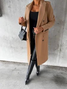 Detail shot of a women's camel wool coat with double-breasted buttons and side pockets.