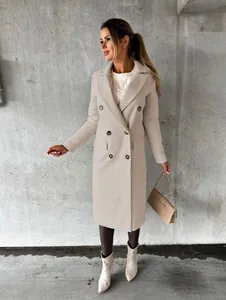 Elegant beige double-breasted woolen coat styled with a cable knit sweater