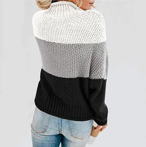 Back view of a chic color-block turtleneck sweater in white, grey, and black chunky knit.