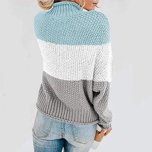 Detailed view of women's chunky knit turtleneck sweater showing texture and stripes