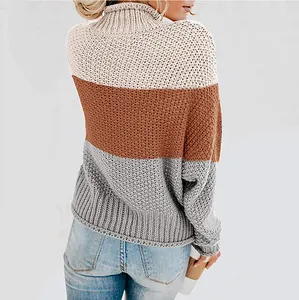 Back view of a chunky knit turtleneck sweater with beige brown and grey color blocks