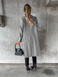 Elegant long grey woolen coat for women, back view with chic black stiletto boots