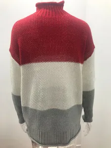 Close-up of women's chunky turtleneck sweater with red, white, and gray color blocks.