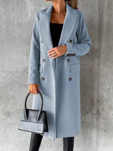 Half-length view of a woman wearing a light blue double-breasted long woolen coat.