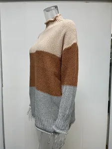 Side profile detail of women's color block turtleneck chunky knit sweater in neutral tones.