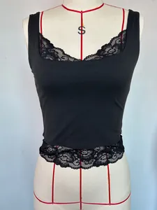 Close-up of black cropped tank top with delicate lace trim on hem and neckline
