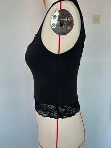 Detailed side view of a black sleeveless cropped tank top featuring elegant lace trim