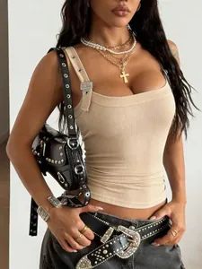 Detailed view of beige ribbed tank top featuring a unique metal buckle on the strap.