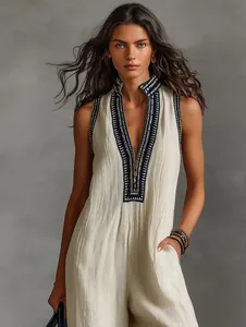 Elegant sleeveless linen blend jumpsuit with embroidered stand collar and zipper.