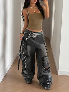 Woman wearing a brown camisole with metal buckle strap detail in a mirror selfie view