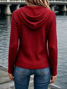 Back view of a slim fit red ribbed long sleeve hoodie for women in a outdoor scene