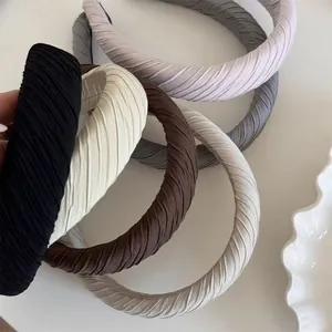 Detail view of colorful pleated padded sponge headbands for women in Korean minimalist style