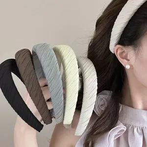 Detailed view of colorful textured sponge headbands worn by a model in Korean style.