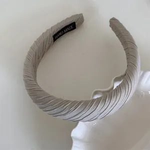 Close-up of Maillard sponge headband with ribbed fabric and handmade label detail.