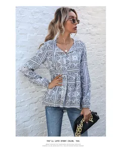 Detailed shot of retro paisley print long-sleeved shirt featuring elegant V-neckline