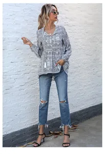 Detailed view of women's vintage boho V-neck long sleeve printed blouse with tassels