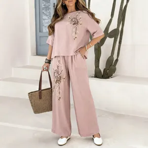 Women's pink cotton linen set featuring vintage floral embroidery and wide-leg pants