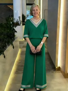 Élégant ensemble deux pièces vert émeraude avec garniture en perles argentées sur modèle