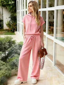Close-up of women's pink hoodie and wide leg pants loungewear set in outdoor setting