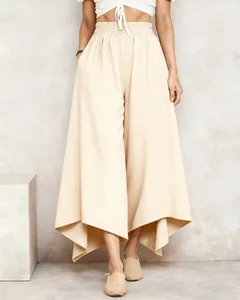 Detail of cream elastic waist wide leg trousers with irregular hem design