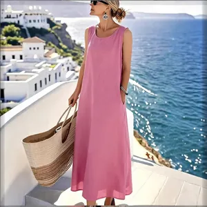 Vestido largo rosa sin mangas de algodón y lino en un soleado entorno costero mediterráneo