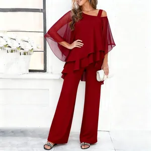 Detailed view of the layered chiffon top and matching wide-leg trousers in burgundy