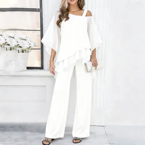 Elegant white two-piece set featuring asymmetrical ruffled top and fluid wide-leg pants.