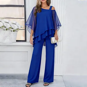 Elegant royal blue two-piece set featuring asymmetrical top with sheer butterfly sleeves.