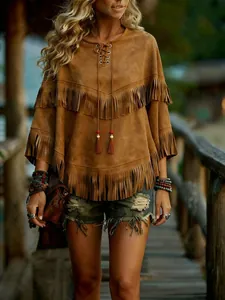 Close-up detail of a brown suede fringed poncho featuring ethnic style batwing sleeves