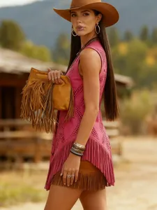 Model wearing a pink hollow-out fringe vest in a rustic outdoor western setting