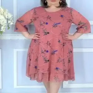 Close-up detail of a pink floral print chiffon dress featuring a layered hem and 3/4 sleeves