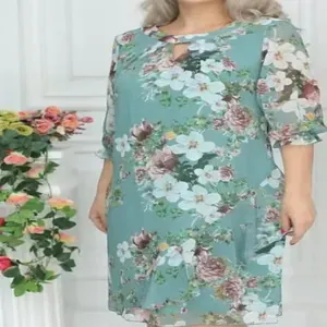 Front view of light teal floral print dress with hollow-out neckline and ruffle cuffs