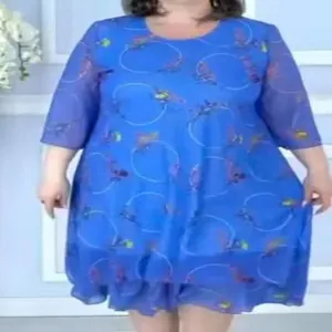 Detail view of a blue chiffon printed dress with layered hem and floral ring patterns