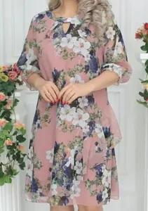 Detailed view of pink floral dress with keyhole neckline and layered skirt