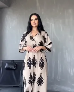 Elegant beige plus size dress with black floral embroidery for summer fashion trends.